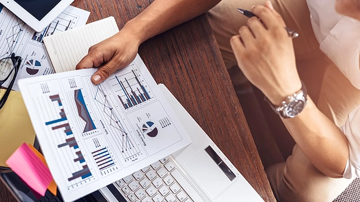 Midsection of woman using mobile phone on table