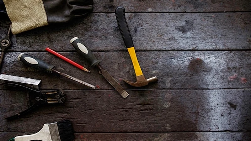 Close-up of work tools on wooden table