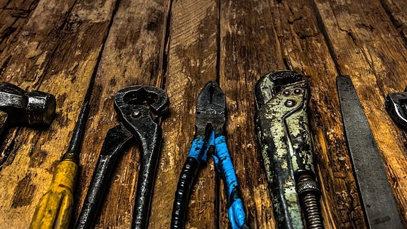 An old rusty set of hand tools on a wooden background