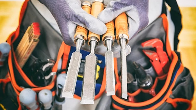 Hands holding set of chisels